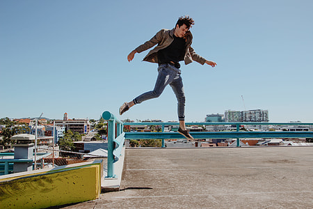 photography of man wearing brown jacket in open air thumbnail