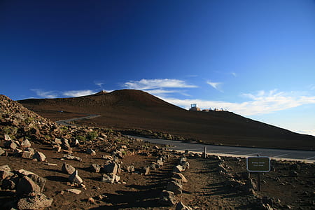 brown mountain under blue and white sky at daytime thumbnail