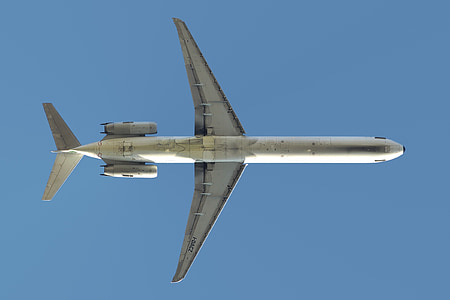 low angle photo of gray plane under blue sky at daytime thumbnail