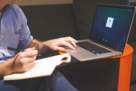 man sitting down while using MacBook Pro thumbnail