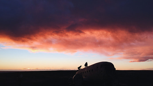 silhouette photography of two persons on top of airplane thumbnail