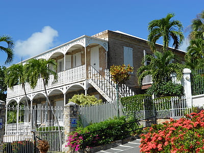 gray and white concrete house under blue skies thumbnail