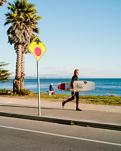 person holding white and red snowboard thumbnail