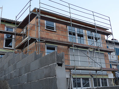brown 3-storey building with scaffoldings thumbnail