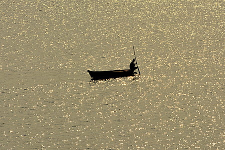 silhouette of person riding boat thumbnail