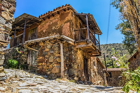 brown stone house under blue sky at daytime thumbnail