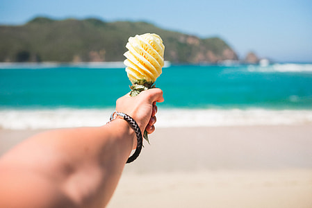 shallow photo of person holding yellow pineapplae thumbnail