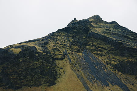 mountain under cloudy sky at daytime thumbnail