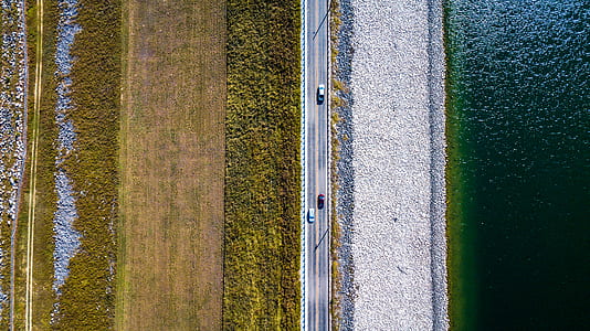 concrete road near body of water thumbnail