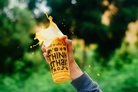 person holding clear plastic cup thumbnail