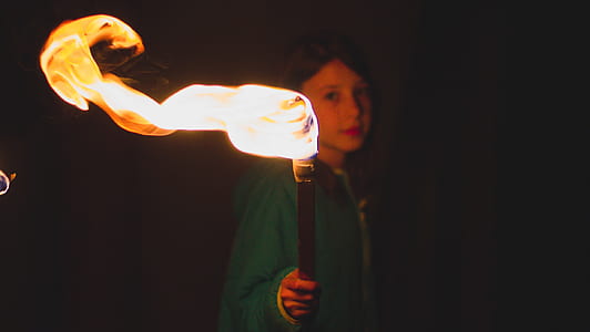 girl holding torch during nighttime thumbnail