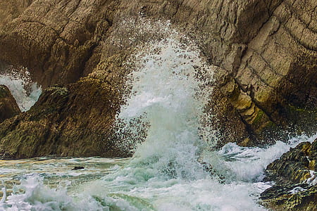 ocean water splash beside cliff thumbnail