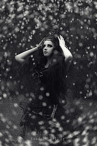 grayscale photo of woman holding her wrought iron crown thumbnail