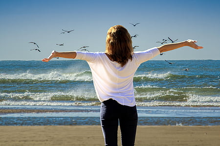 woman wearing white shirt and black pants on beach thumbnail