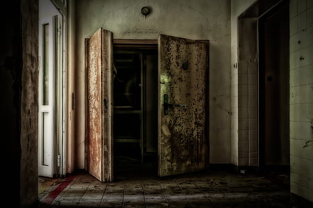 opened rusty brass-colored door inside white room thumbnail