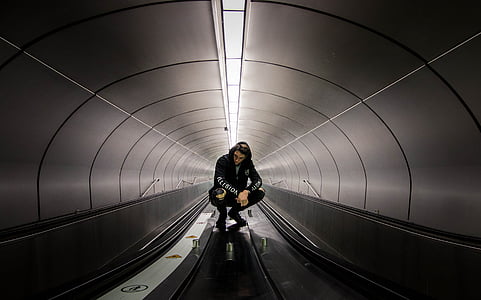 man sitting in gray hallway thumbnail
