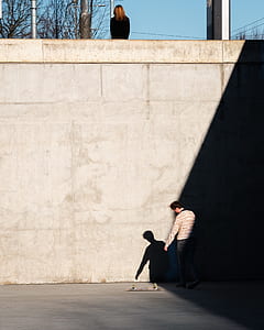 man standing in front of wall thumbnail