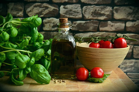 cherry tomatoes, green spinach and olive oil sitting on the table thumbnail