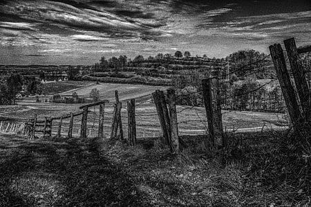 grayscale photo of fence near grass field thumbnail