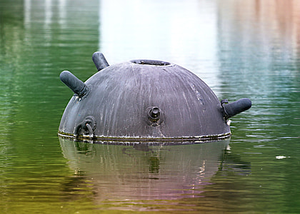 round gray container on body of water thumbnail