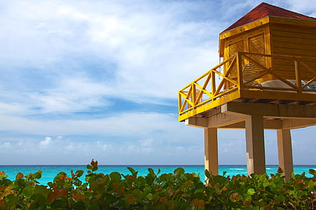 brown wooden house under cloudy sky thumbnail
