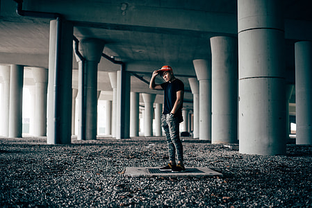 man standing between concrete posts thumbnail