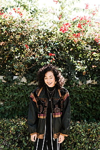 woman standing beside hedge while smiling thumbnail