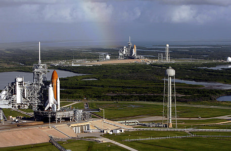 white and orange rocket on gray metal building thumbnail