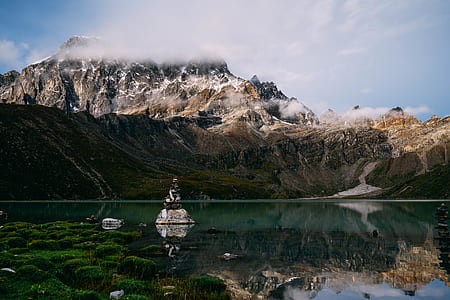 landscape photography of mountain and body of water thumbnail
