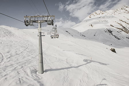 people on ski lift on mountain thumbnail