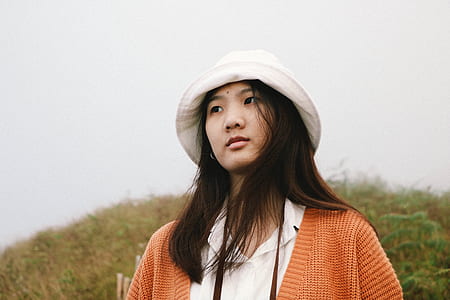 woman standing near grass at daytime thumbnail