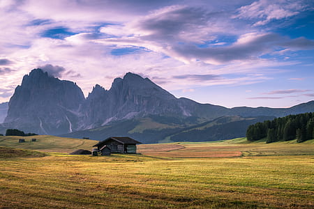 landscape photography of shack under nimbus clouds thumbnail