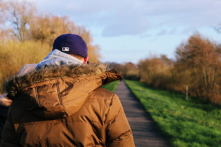 person wearing blue fitted cap during daytime thumbnail
