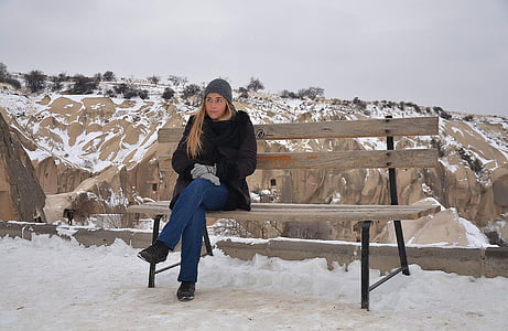 woman sitting on brown outdoor bench thumbnail