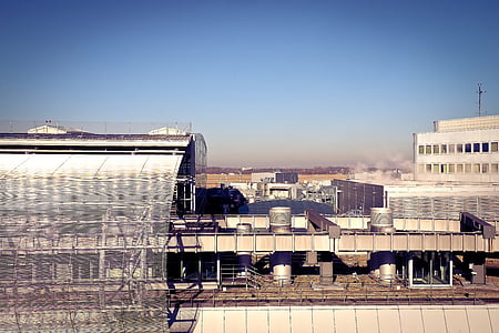 photo of gray painted industrial building under blue sky thumbnail