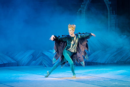 man wearing crown performing on stage thumbnail