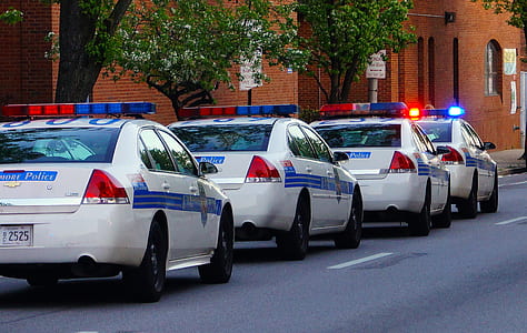 four white police cars on road thumbnail