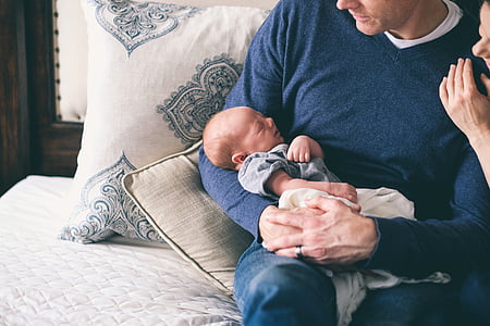 man carrying baby thumbnail