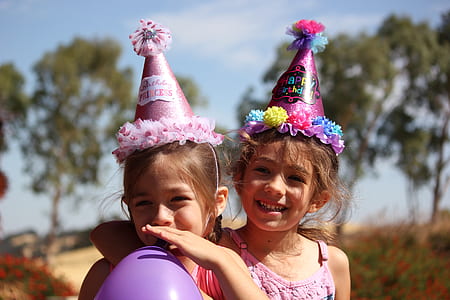 two girl in party hats thumbnail