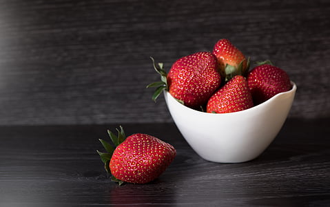 strawberries in jar while 1 is on black surface thumbnail