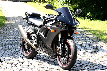 black and gray sports motorcycle on gray brick pathway thumbnail