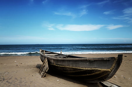 brown wooden boat on shore during daytime thumbnail