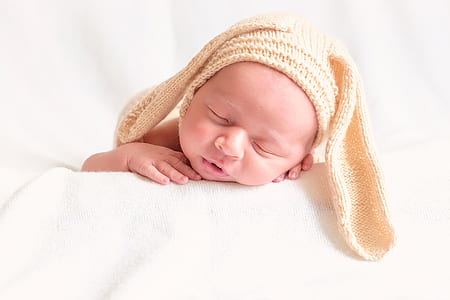 baby wearing beige rabbit beanie thumbnail