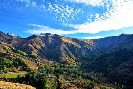 aerial view of mountains under blue sky during daytime thumbnail