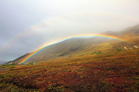 landscape photography of green mountain with rainbow thumbnail