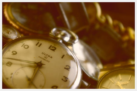 close-up photography of silver-colored pocket watch thumbnail