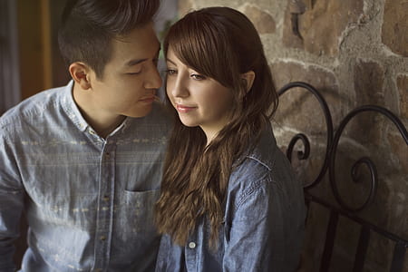 woman and man sitting near brown wall thumbnail