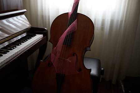 brown violin beside brown upright piano thumbnail