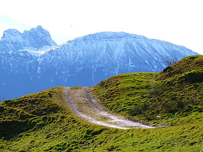 green grass field near mountain thumbnail