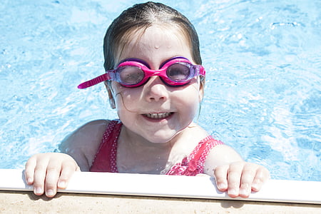 girl wearing swimming goggles soaking on body of water thumbnail